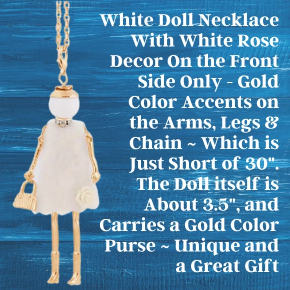 Doll Necklace On Long Chain White Dress With White Flower Lower Front Of Dress